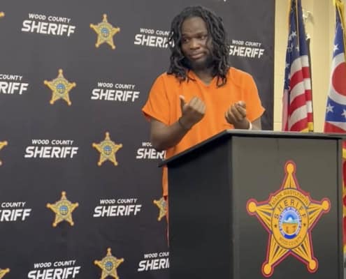 Fostoria News Woman speaking at a podium during a sheriff's event in Fostoria.